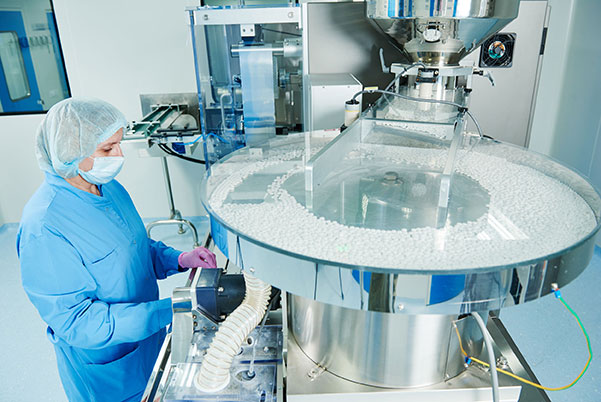 Copyright Dmitry Kalinovsky Pharma Industry Worker Wearing Face Mask Operates Tablet Blister Packaging Machine 62489069 M 1, Industry Today