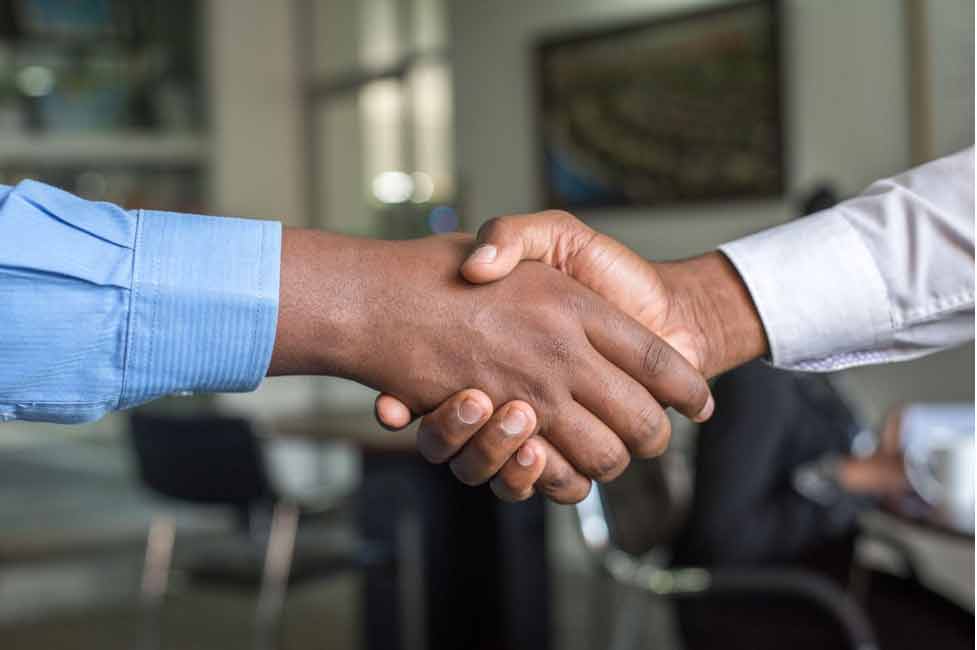 two people shaking hands for agreement