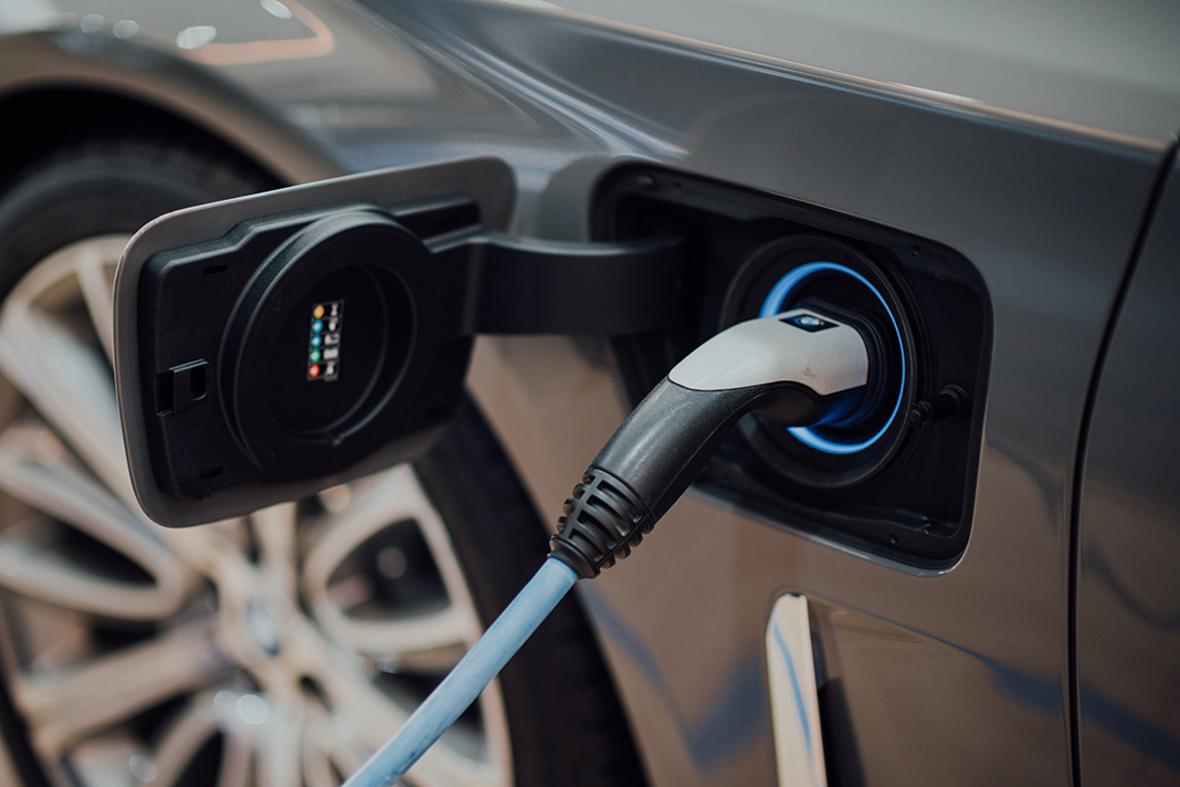 An EV charging. EVs are the perfect vehicle for conscious consumers wanting to positively impact sustainability efforts. Photo by CHUTTERSNAP on Unsplash