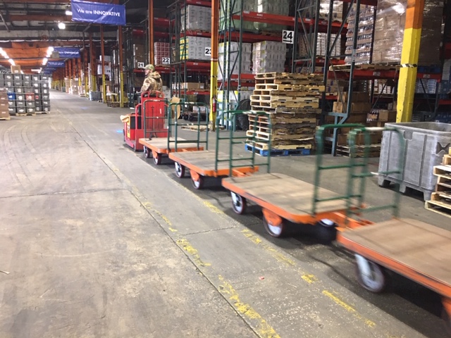 The trailers are utilized behind electric tow tractors with multiple units used to increase picking rates.
