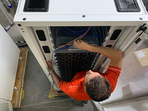 Kelser Systems Engineer Rob Backus customizes IT hardware. Manufacturing networks are often a hybrid of on-premises and cloud servers.
