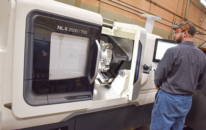 Enerquip Machinist Tyler Komarek begins operation of the company’s newest lathe, a DMG MORI NLX 2500/700.