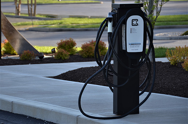 A high-power electric vehicle charging station placed outside for EV owners to use. The charger powers a lithium battery. Photo by Roger Starnes Sr on Unsplash