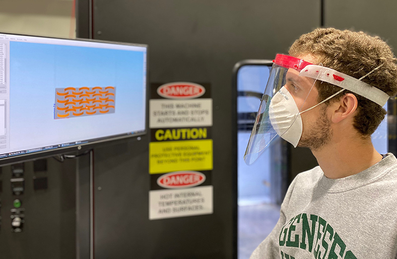 Titan Robotics engineer Anthony Tantillo demonstrates a 3D printed face shield made on the Titan Atlas 3D printer with pellet extrusion.