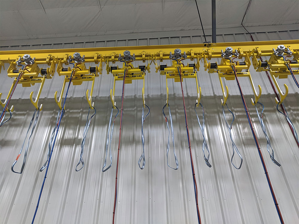 The installation includes 20 custom, wire rope, air-operated hoists with double sister hooks.