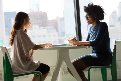 Two Women At Table In Front Of Window, Industry Today