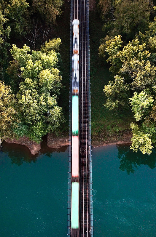 train cars on track going over water image sid suratia unsplash
