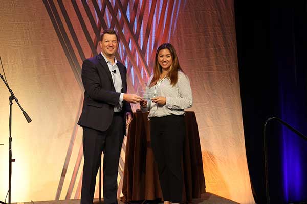 female leader accepting korber supply chain recognition