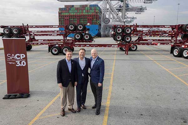 ccm executives in front of chassis stacked on flatbed