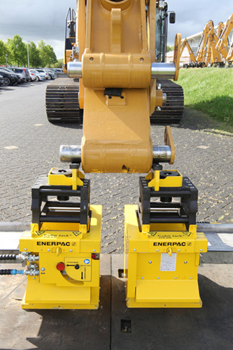 Enerpac cube jacks supporting the excavator boom and arm.