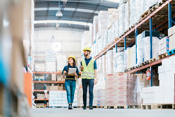 two workers walking through warehouse