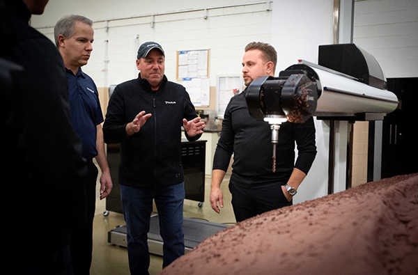 <i>Siemens Machine Tool Systems account manager, Chris Grimm, looks on as TARUS CEO Dave Greig describes the new speed and accuracy of the TARUS Claymill due to the processing power of the SINUMERIK ONE control.</i>